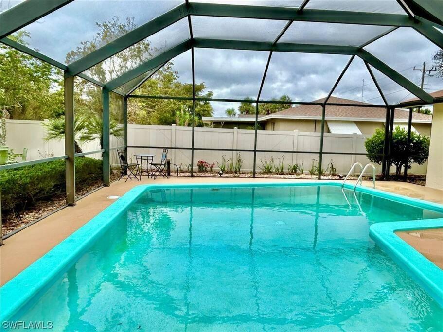 a swimming pool with a pergola over it at Beautiful 3 Bed House with pool in North Fort Myers