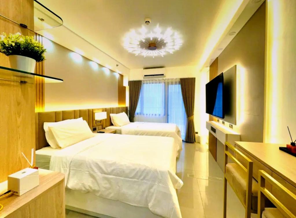 Ліжко або ліжка в номері Hotel-Like Staycation2 MOA Pasay