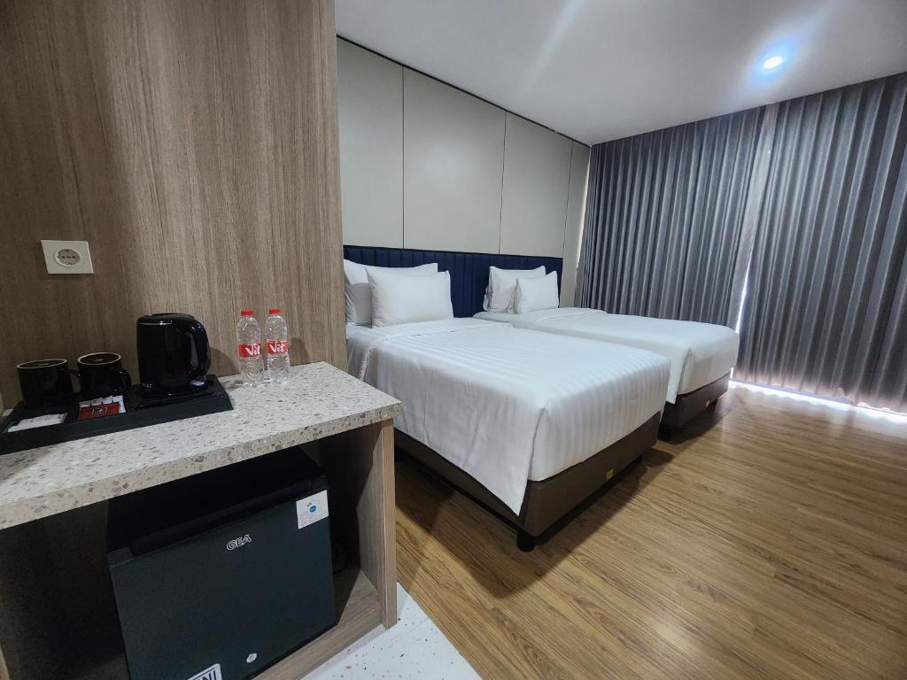 Postel nebo postele na pokoji v ubytování Gulala Azana Hotel & Resort Guci Tegal