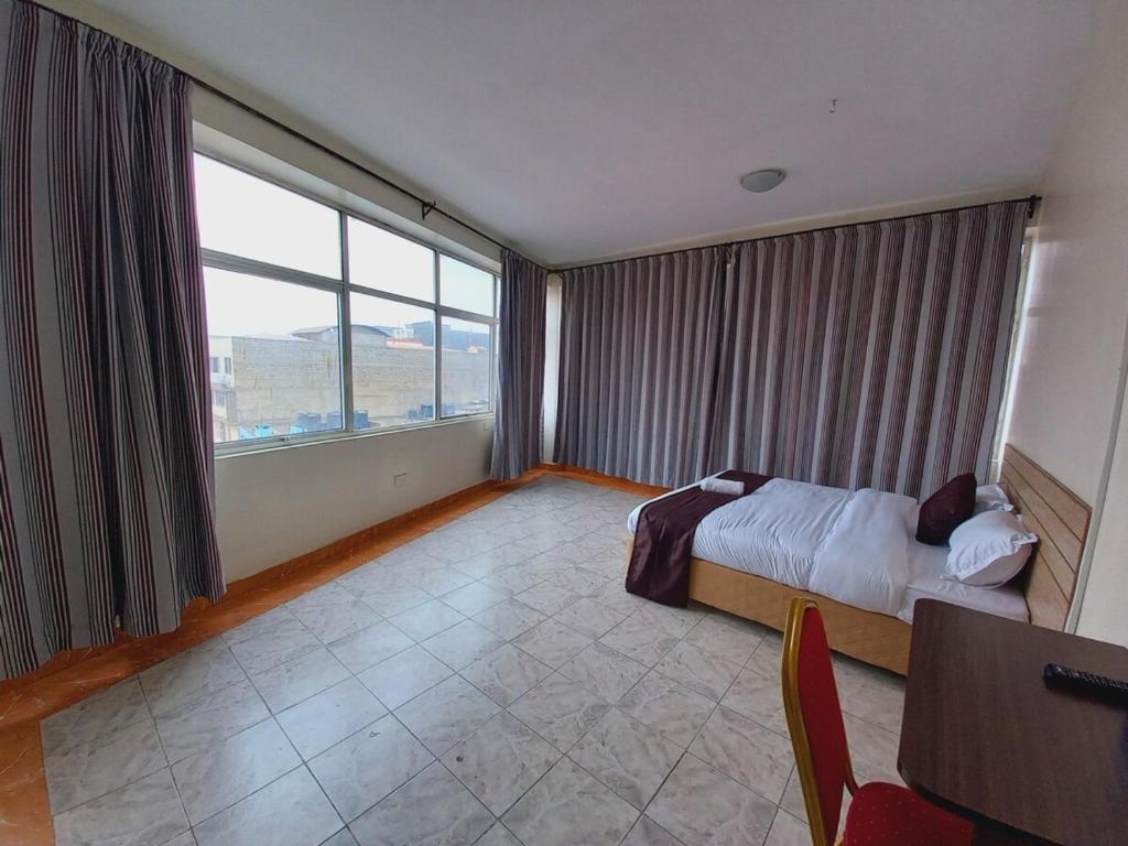 Postel nebo postele na pokoji v ubytování Fahari Bliss Hotel
