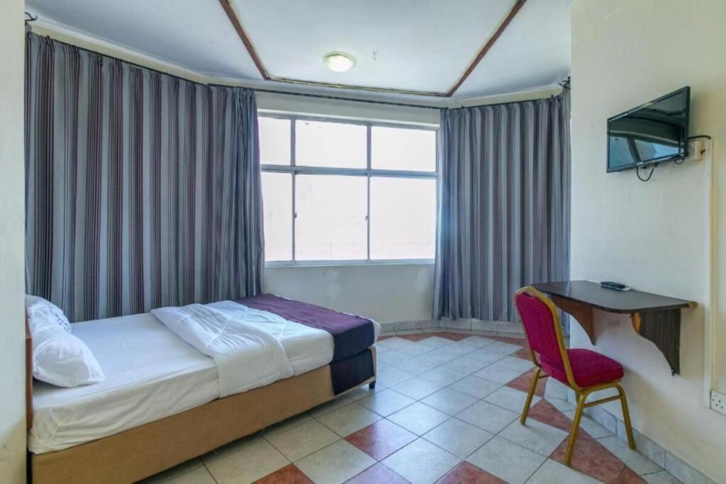 Postel nebo postele na pokoji v ubytování Fahari Bliss Hotel