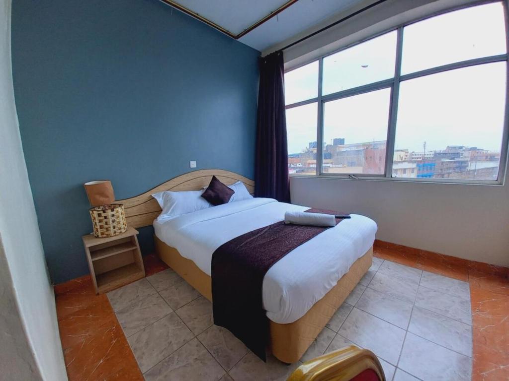 Postel nebo postele na pokoji v ubytování Fahari Bliss Hotel