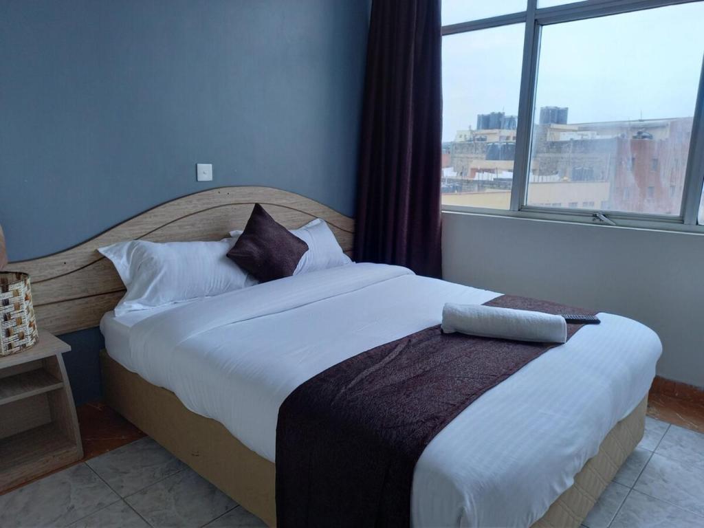 Postel nebo postele na pokoji v ubytování Fahari Bliss Hotel