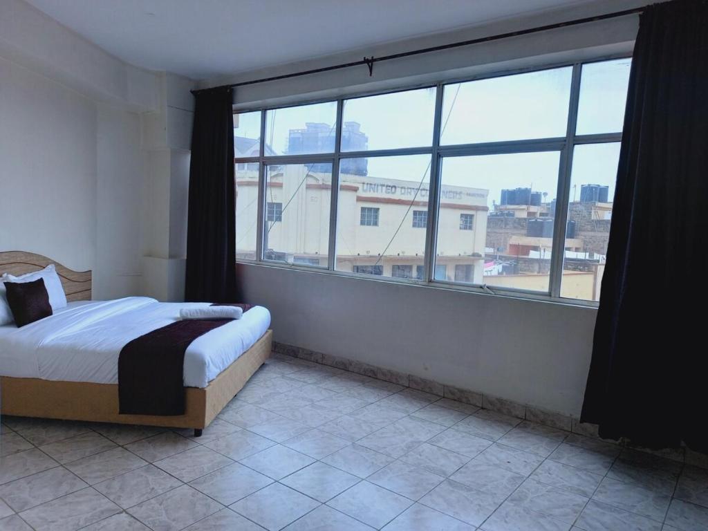 Postel nebo postele na pokoji v ubytování Fahari Bliss Hotel