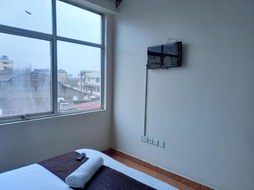 Postel nebo postele na pokoji v ubytování Fahari Bliss Hotel