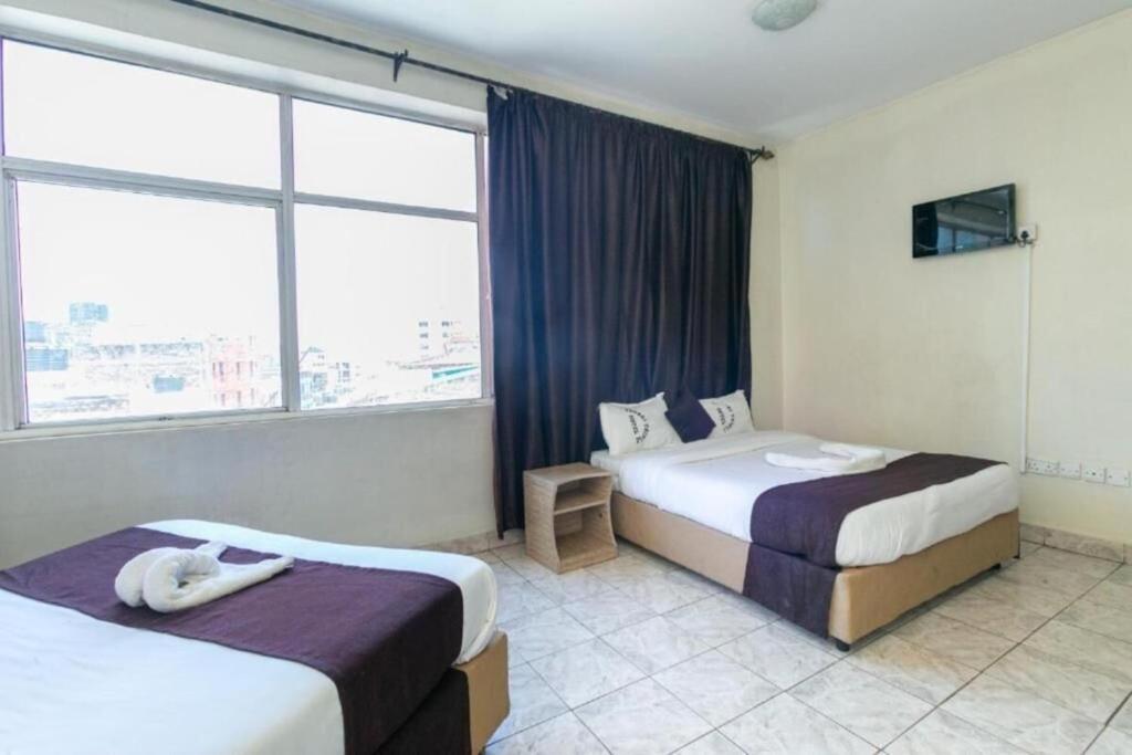 Postel nebo postele na pokoji v ubytování Fahari Bliss Hotel