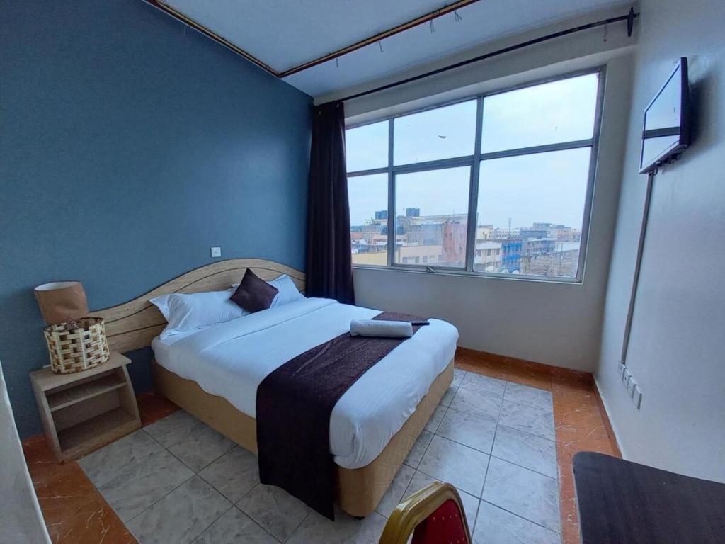 Postel nebo postele na pokoji v ubytování Fahari Bliss Hotel