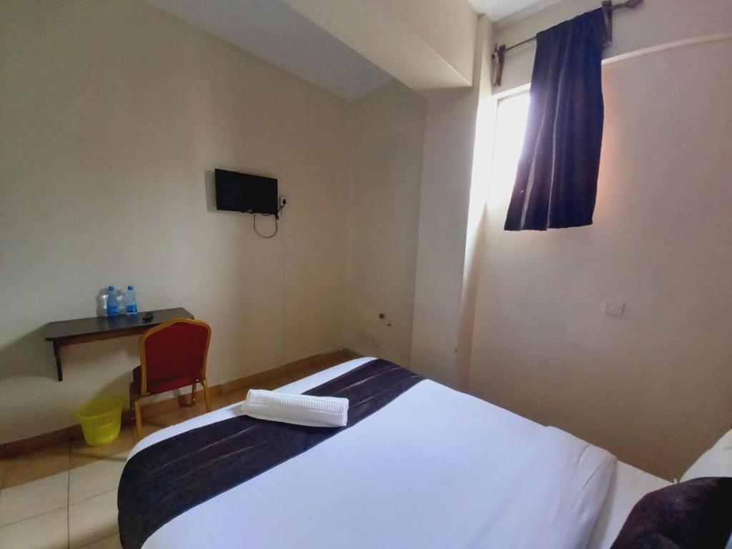Postel nebo postele na pokoji v ubytování Fahari Bliss Hotel