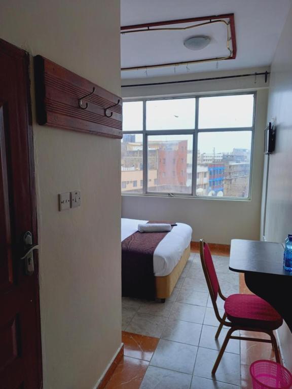 Postel nebo postele na pokoji v ubytování Fahari Bliss Hotel