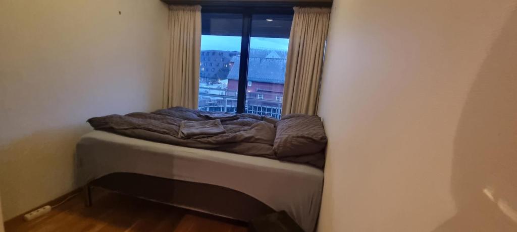 a bed in a corner of a room with a window at The Seaview Suite - Tromsø harbour! in Tromsø
