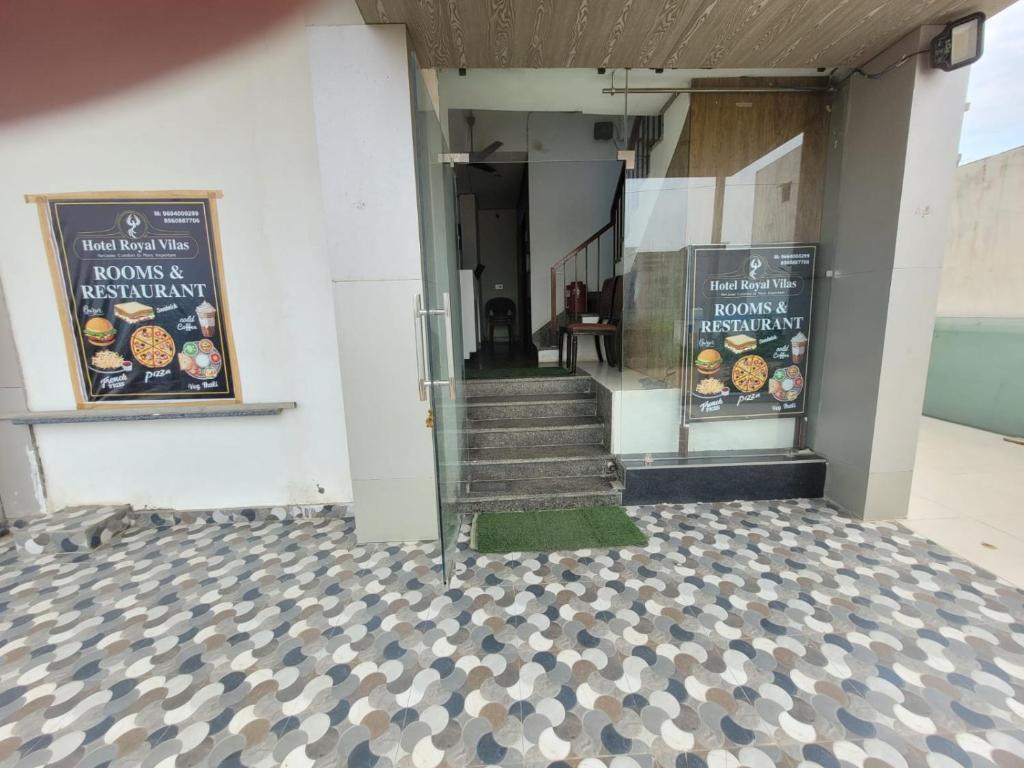 a building with stairs and signs on the side of it at Hotel Royal Vilas in Bharatpur