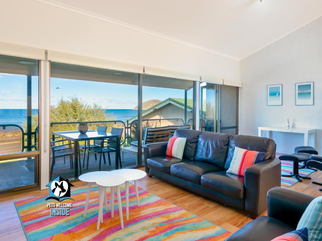 a living room with a couch and a table at Beautiful Sea Front 3BR with Great Views in Encounter Bay