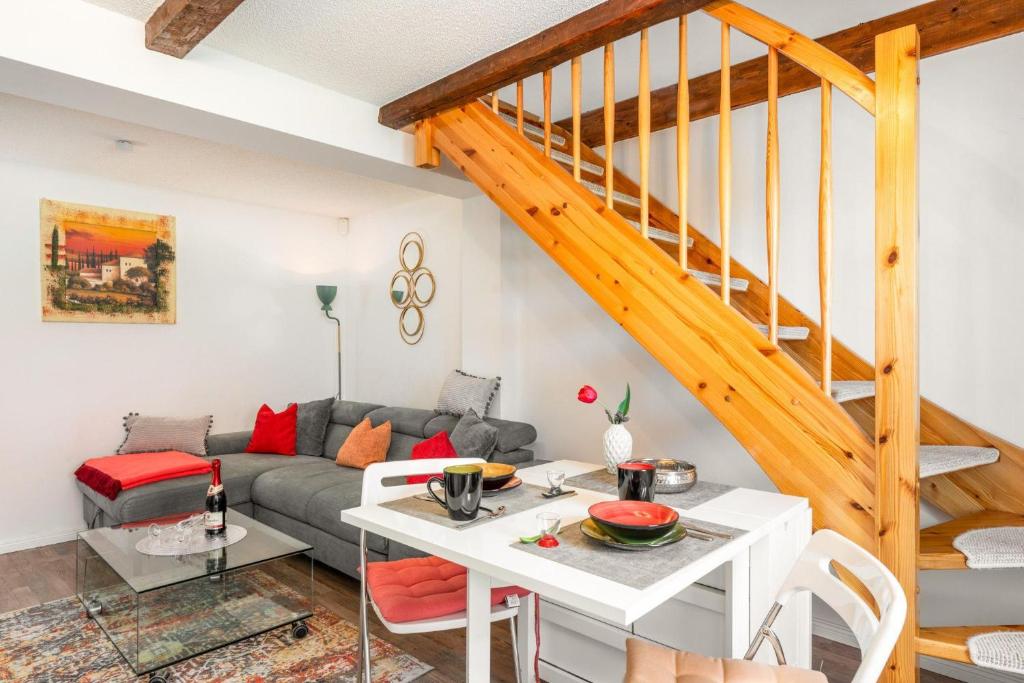 a living room with a couch and a staircase at Ferienhaus-am-Osterberg in Allrode