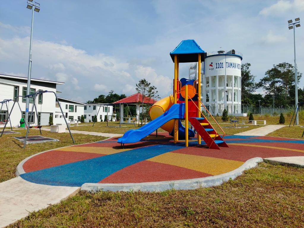 a playground with a slide in a park at Daisy Homestay Kota Tinggi in Kota Tinggi