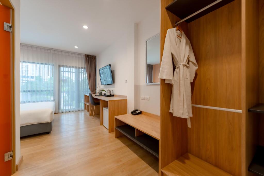 A view of the open wardrobe, dressing area and room beyond.