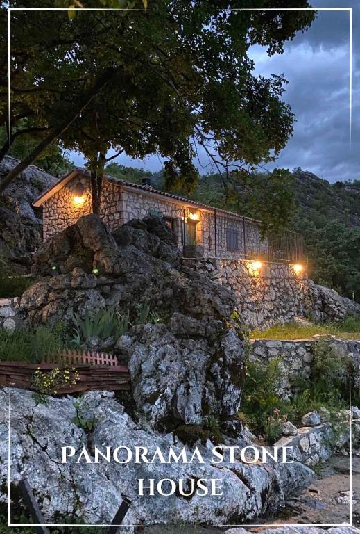 a stone house on top of a mountain at night at Panorama Stone Houses - Skadar Lake in Cetinje