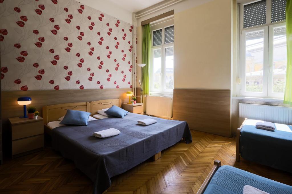 A bed or beds in a room at East Station Private Rooms