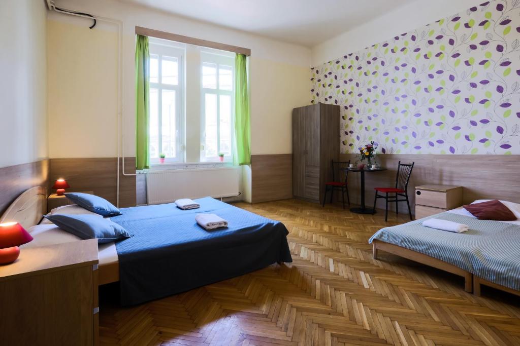 A bed or beds in a room at East Station Private Rooms