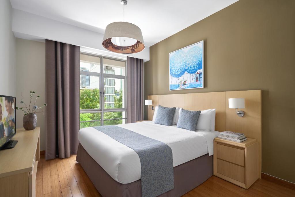Postel nebo postele na pokoji v ubytování Somerset Ho Chi Minh City
