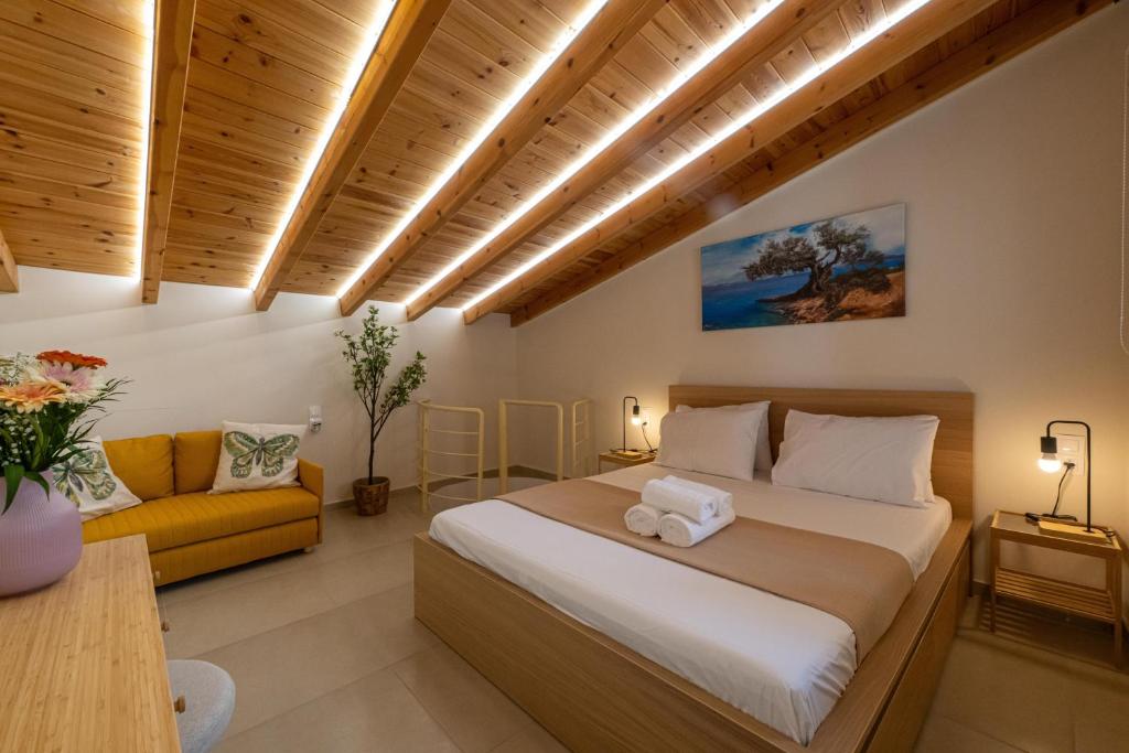 a bedroom with a bed and a couch at HomEasy Apartments - Kalamata Central Getaways with Private Parking in Kalamata