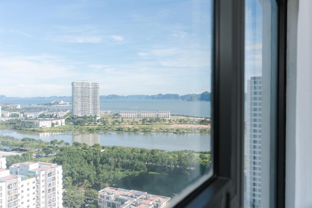 a view of a lake from a window at By's House- Căn hộ View biển Hạ Long in Ha Long