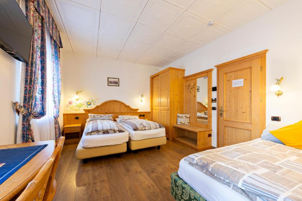 Postel nebo postele na pokoji v ubytování Monza Dolomites Hotel