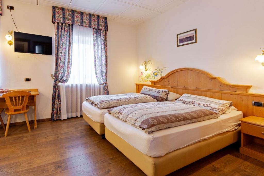 Postel nebo postele na pokoji v ubytování Monza Dolomites Hotel