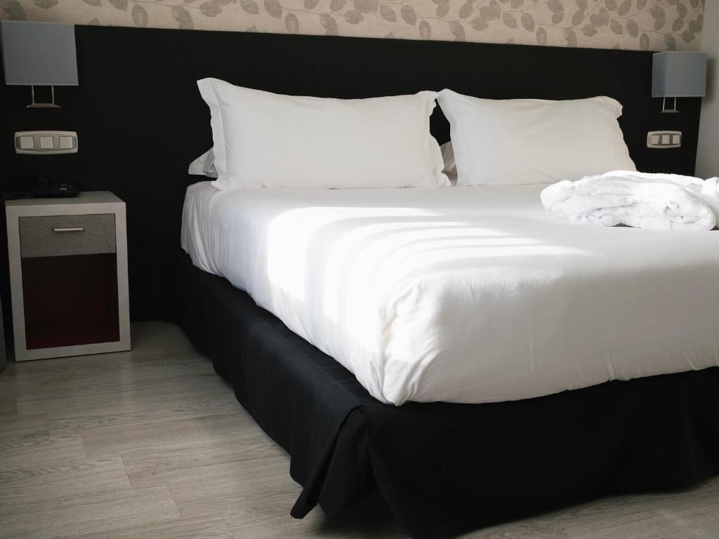 Postel nebo postele na pokoji v ubytování Hotel Plaza Las Matas