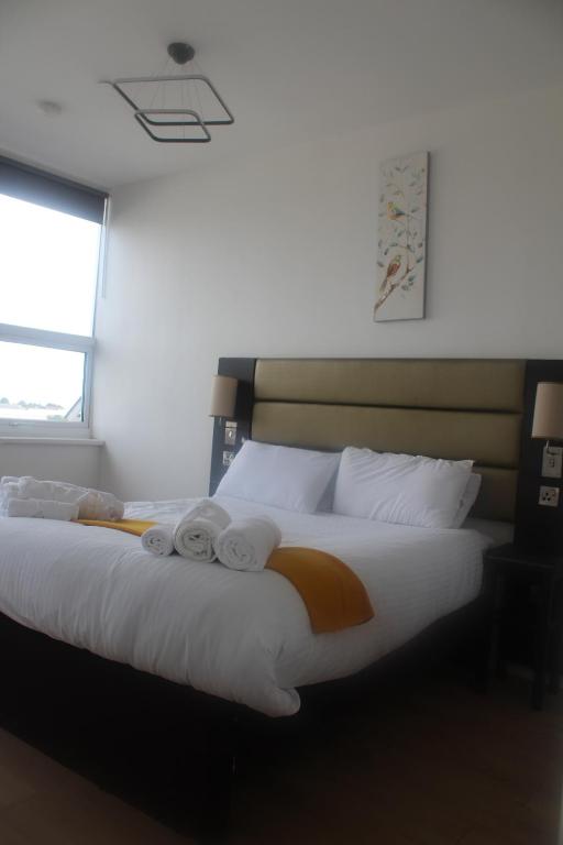 a bedroom with a large bed with towels on it at Flat 414 One bedroom apartment in Birmingham