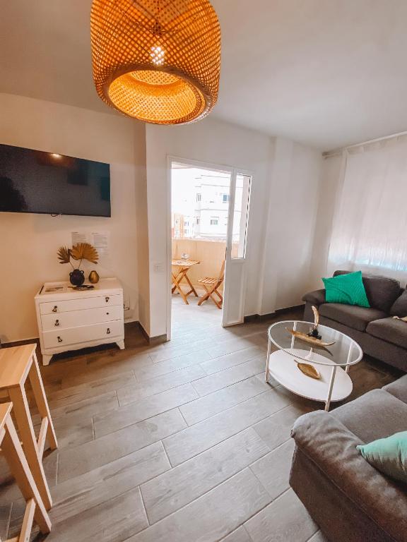 a living room with a couch and a table at Pitayas Apartment in Corralejo