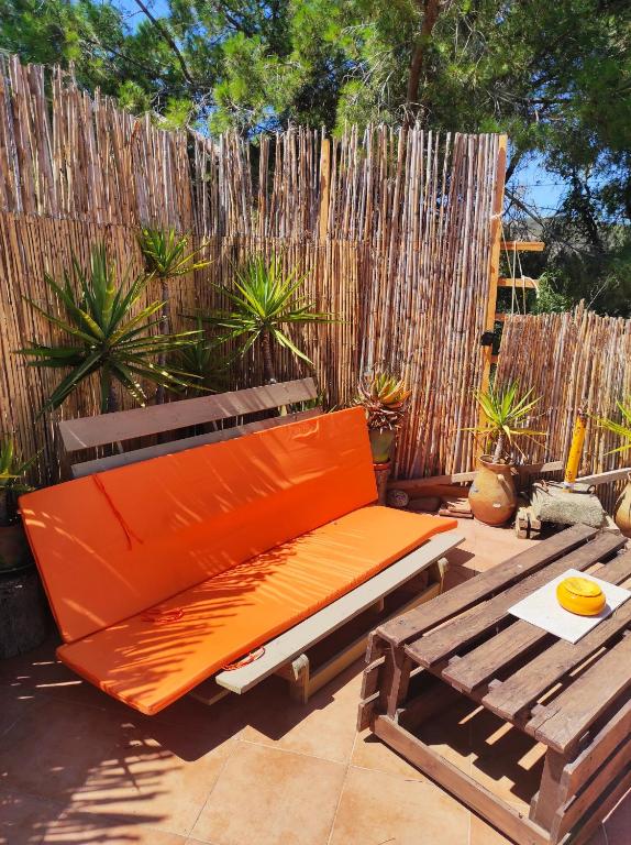 an orange bench sitting on a patio next to a fence at Casa da Cabana in Budens