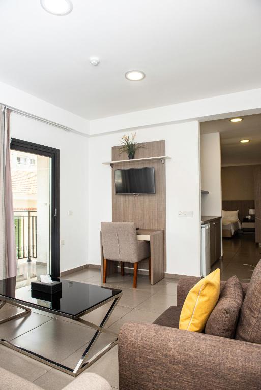a living room with a couch and a table at Rise Urban Art Hotel in Larnaca