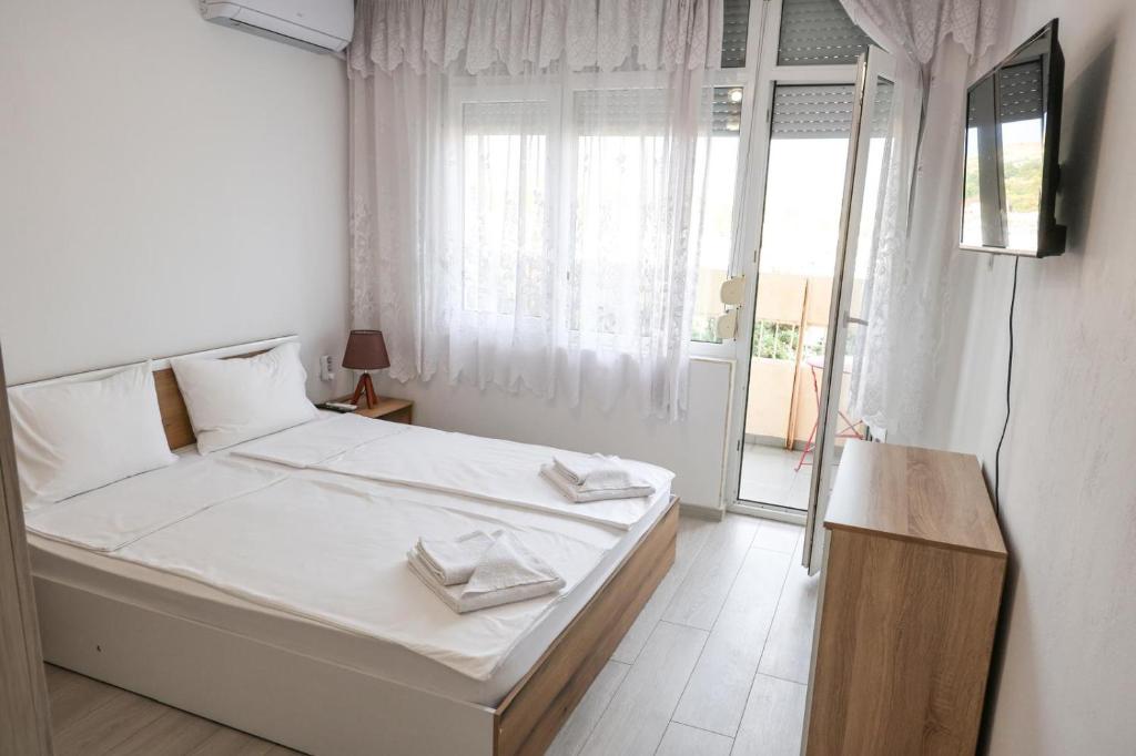 Ένα ή περισσότερα κρεβάτια σε δωμάτιο στο Kris Apartment