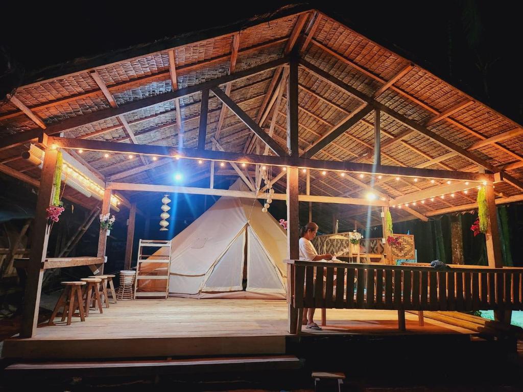 a man standing on a stage with a tent at Kubo ni Apple in Tagbina