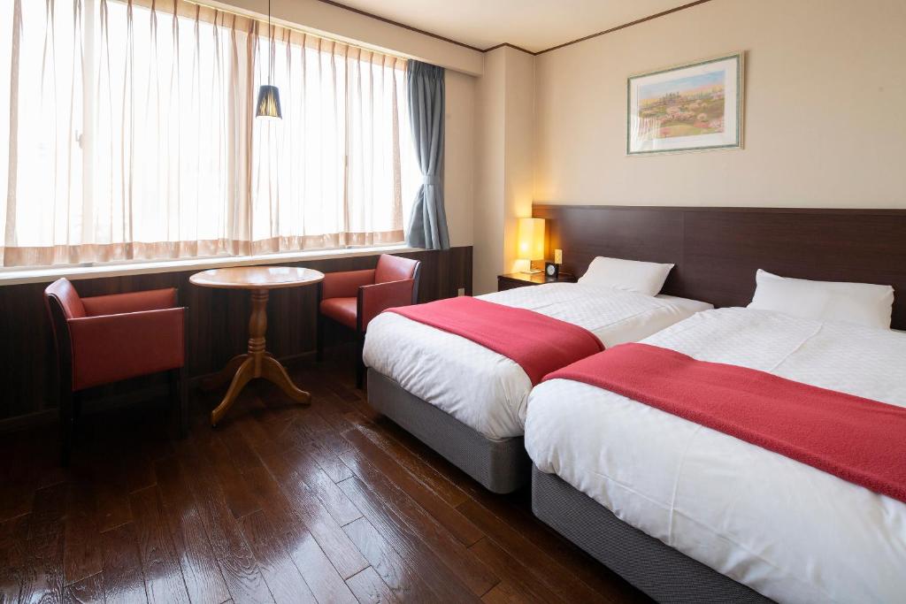 Postel nebo postele na pokoji v ubytování Hotel Claire Higasa