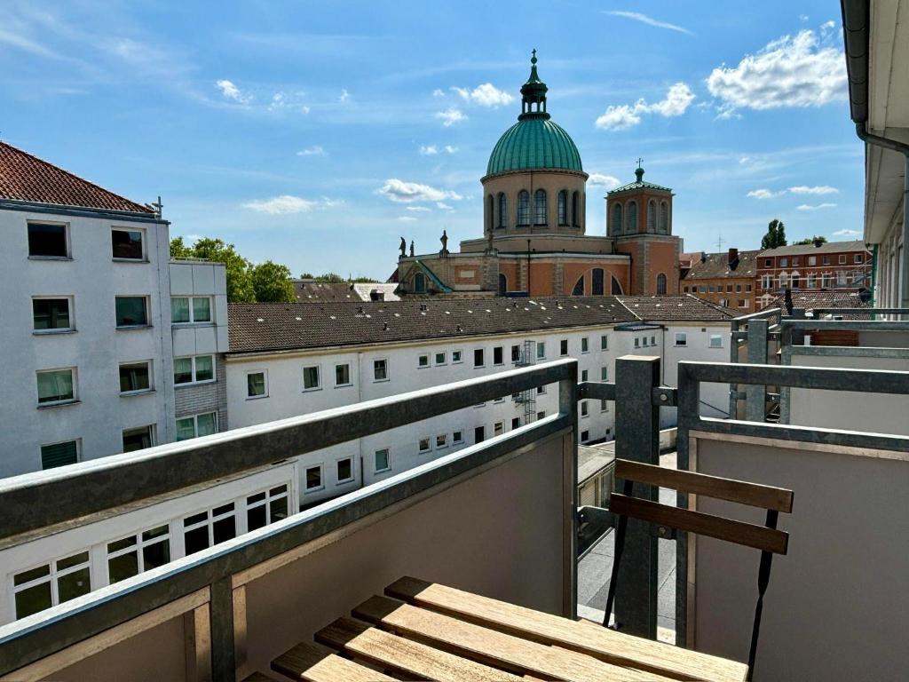 a balcony with a view of a city at Banksy Apartment - Art & Fun mit 2 Balkonen - 6 Betten in Hannover