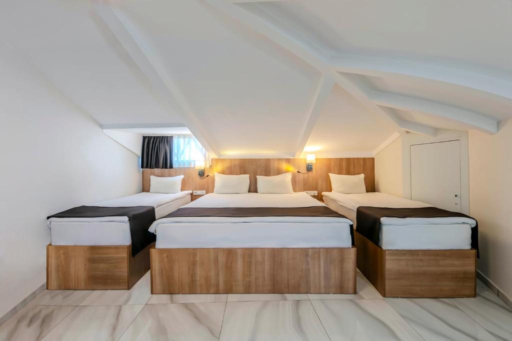 A bed or beds in a room at Silvana Hotel