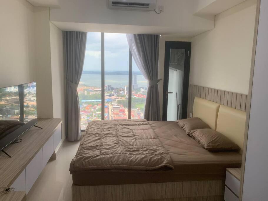 En eller flere senge i et værelse på COMFORTSTAY-Pollux Mall Batam Center TOWER B #3902