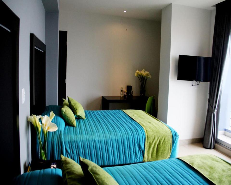 Postel nebo postele na pokoji v ubytování Hotel Misión Express Xalapa