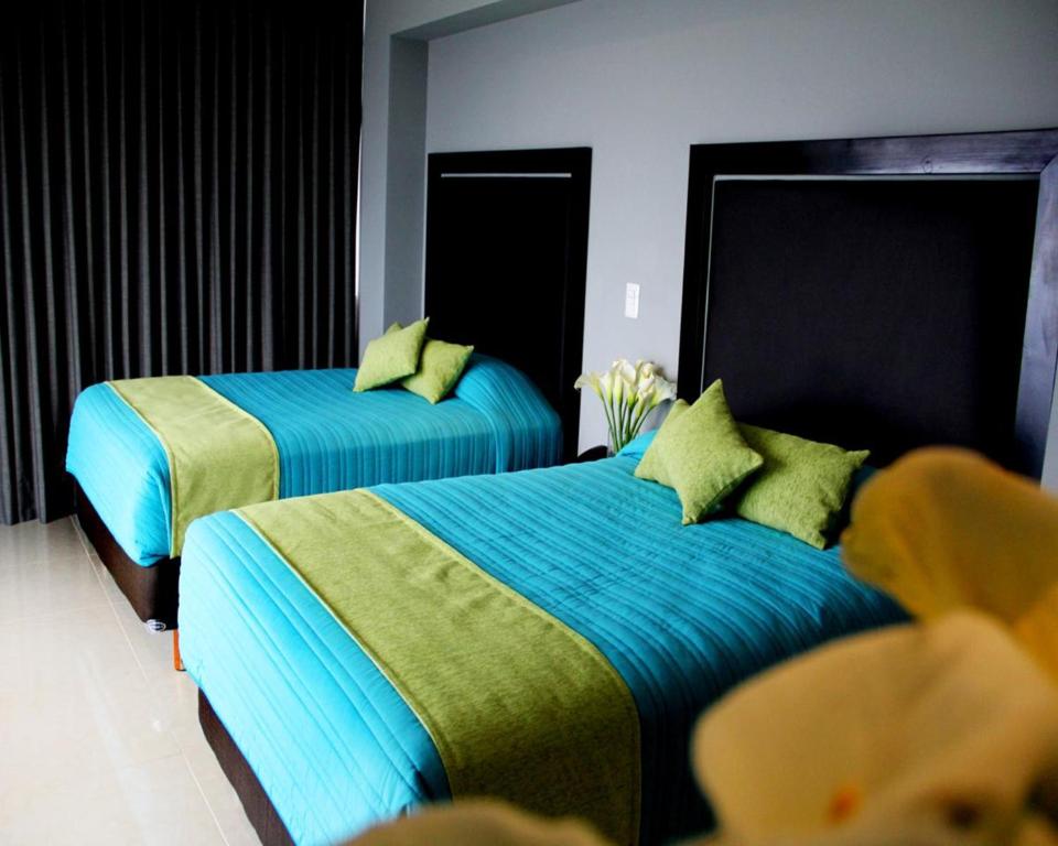 Postel nebo postele na pokoji v ubytování Hotel Misión Express Xalapa