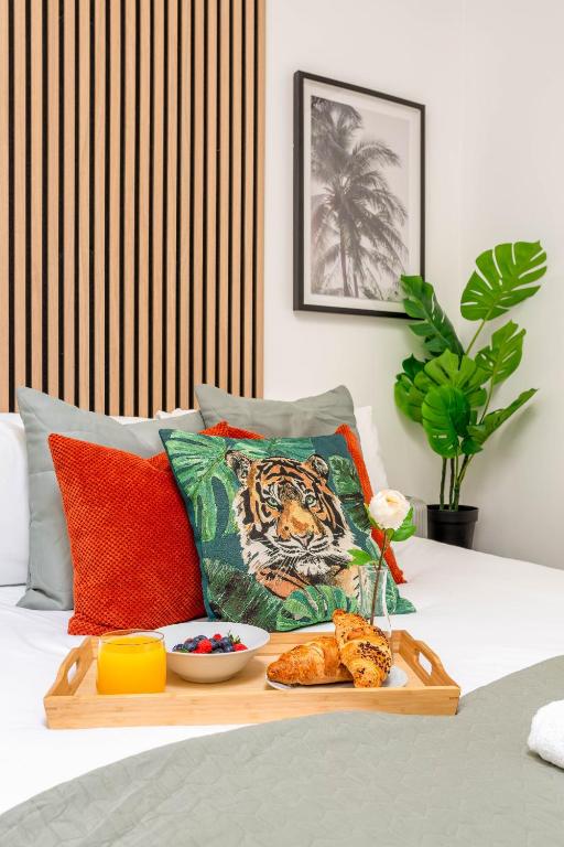 a tray of food on top of a bed at Cozy Kingfisher - 2-Bed Bungalow in Brighton near the Beach With Free WiFi & Terrace by Kozmo Properties in Brighton & Hove
