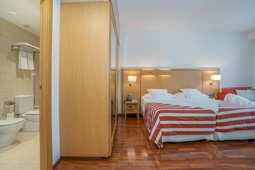 Postel nebo postele na pokoji v ubytování Hotel Duran