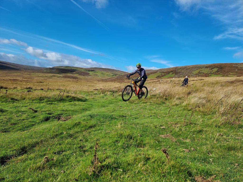 a person riding a bike on a grassy field at Westwood Farm in Kirkby Stephen