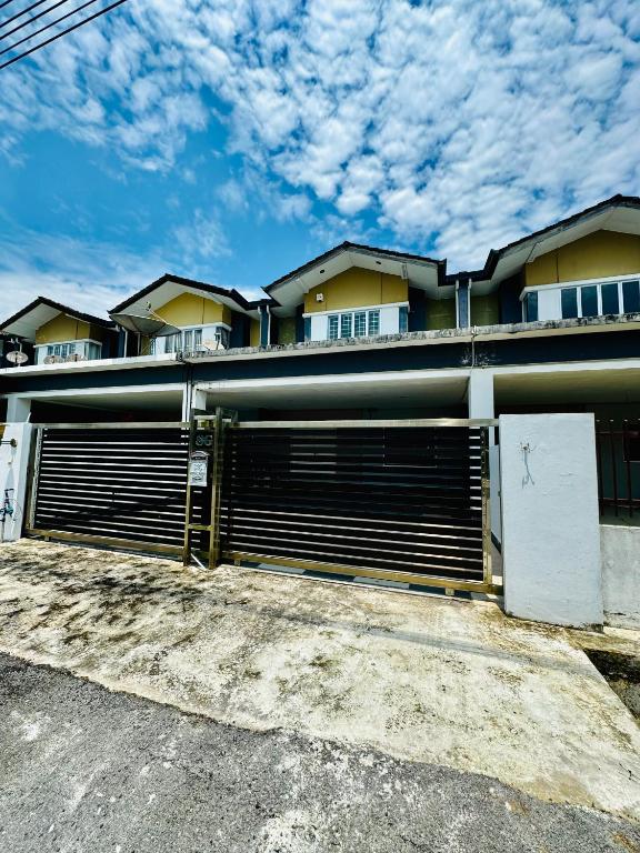 a building with two garage doors in a parking lot at HmHome-Four in Rumah Ide