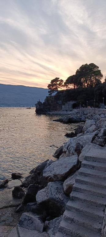 a group of stairs on the shore of a body of water at Appartement Carpe diem vue mer in Herceg-Novi