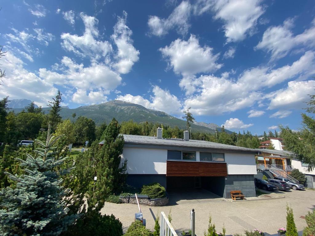 a house with a mountain in the background at Mountain Villas Polana in Starý Smokovec
