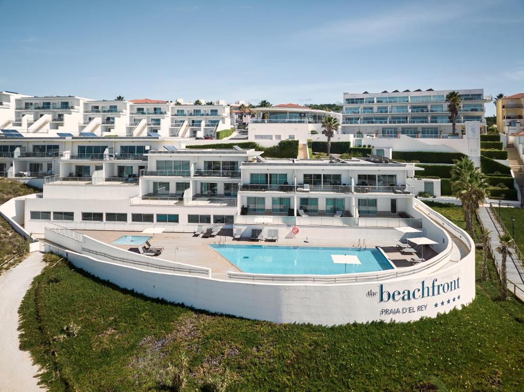 a large white building with a boat in front of it at The Beachfront - Praia D'El Rey Golf & Beach Resort in Casal da Lagoa Seca