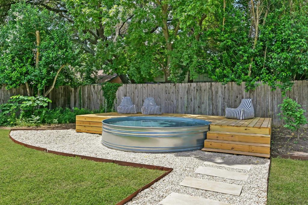 a fire pit in a yard with two chairs and a fence at Austin Oasis Zilker, Downtown, Pool, 3 Bedroom in Austin