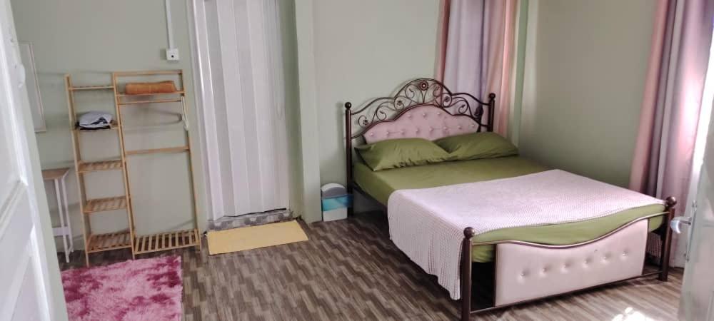 Postel nebo postele na pokoji v ubytování WM Homestay Kota Bharu