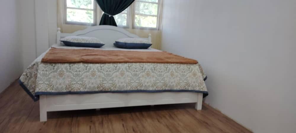 Postel nebo postele na pokoji v ubytování WM Homestay Kota Bharu